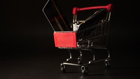 Credit-card-falling-down-on-mini-shopping-cart