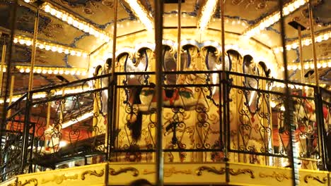 Colorful-illuminated-carousel-on-Christmas-fair-on-Red-Square.-Buildings-and-trees-decorated-for-New-Year-celebration