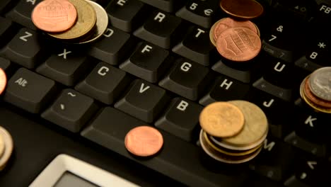 Coins-on-a-laptop-isolated-on-white-background