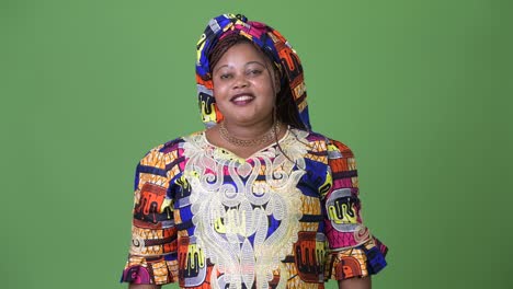 Overweight-beautiful-African-woman-wearing-traditional-clothing-against-green-background