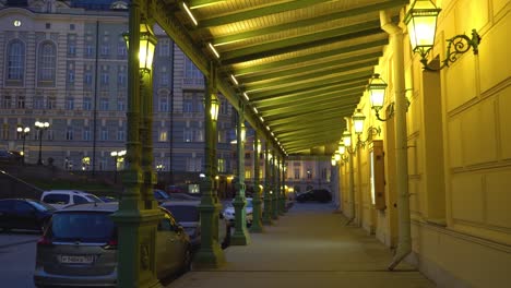 Bolshoi-Theater,-Moscow,-Russia.-Walking-along-the-aisle-with-columns-at-night