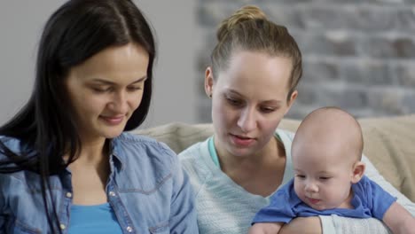 Female-Couple-Spending-Time-with-Baby