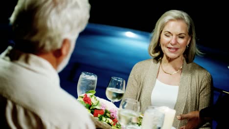 Senior-Caucasian-couple-dining-at-tropical-resort-hotel