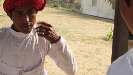 Rajasthani-male-in-ethnic-wear-grooming-himself-in-front-of-mirror