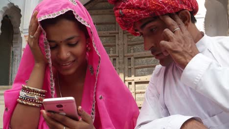 Good-looking-couple-worried-concerned-about-bad-news-from-the-internet-on-smart-cell-mobile-phone-screen