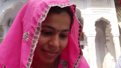 Close-up-of-Rajasthani-couple-tense-worried-sweating-remorse-in-traditional-dress-in-from-of-traditional-architecture-gate