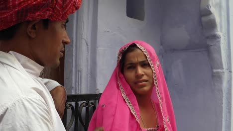 Man-asking-for-forgivness-for-being-late-to-his-beautiful-woman-in-traditional-dress-in-Rajasthan-India