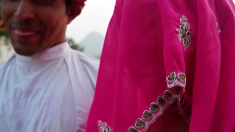 Closeup-handheld-portrait-of-Indian-husband-with-turban-and-shy-wife-in-sari-traditional