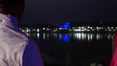 Pan-left-Indian-traditional-romantic-couple-at-Pushkar-Lake-in-night