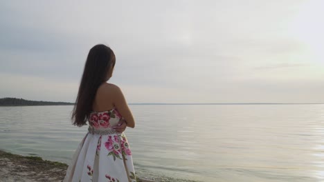 Brunette-in-long-dress-standing-by-the-river