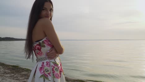 Charming-girl-in-a-long-dress-standing-by-the-river