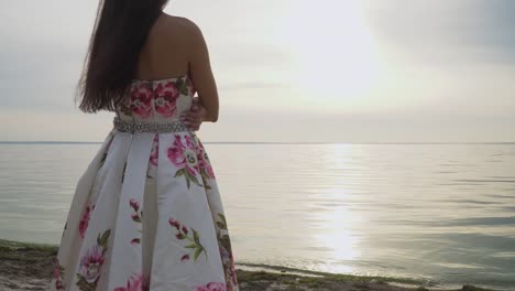 Charming-brunette-in-a-long-evening-dress-standing-by-the-river