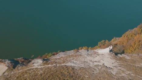 Young-and-beautiful-wedding-couple-walking-together-on-the-slope-of-the-mountainnear-sea.-Lovely-groom-and-bride.-Shooting-from-the-air.-Aerial-shot