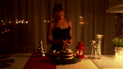 Young-woman-lighting-a-Sparkler-in-the-cake-at-night-at-Christmas-time