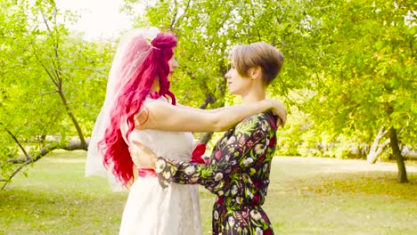 Lesbian-wedding.-The-bride-and-groom-are-hugging-each-other-and-talking