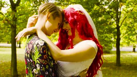 Lesbian-wedding.-The-bride-and-groom-are-hugging-each-other-and-talking