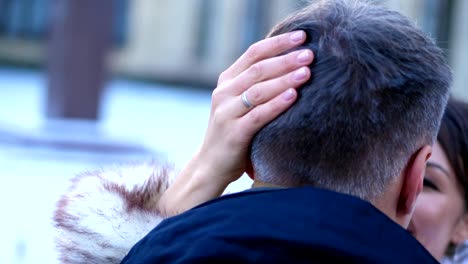 boda-de-invierno,-primer-plano,-que-la-novia-acaricia-la-parte-posterior-de-la-cabeza,-el-pelo-de-su-marido.-hermosa-manicura-en-tonos-suaves-y-un-anillo-en-un-dedo