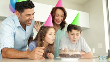 Father-lighting-candles-on-birthday-cake-for-his-son