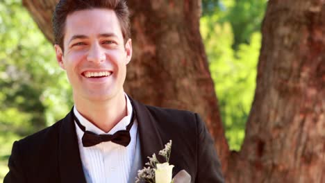 Happy-groom-laughing-and-smiling-at-camera