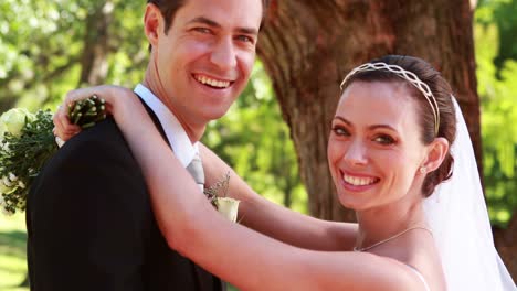 Newlyweds-dancing-together-and-smiling-at-camera