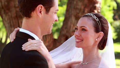 Young-newlyweds-dancing-together-and-smiling