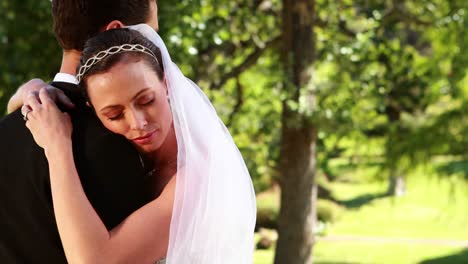 Smiling-bride-hugging-her-new-husband