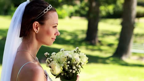 Smiling-bride-smelling-her-bouquet