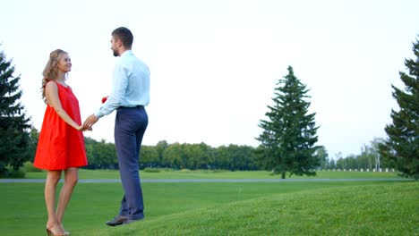 Guy-doing-the-girl-proposal-in-the-middle-of-a-beautiful-park.