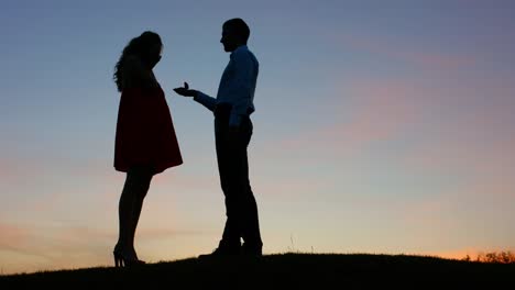 Guy-doing-the-proposal-for-girl-against-a-beautiful-sky.