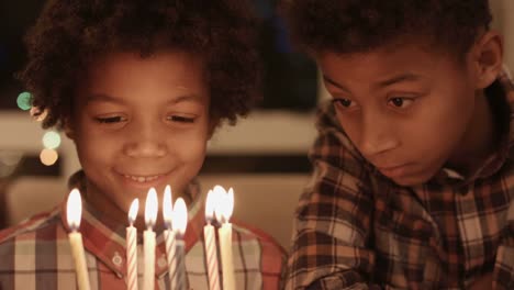 Thoughtful-boys-near-birthday-cake.