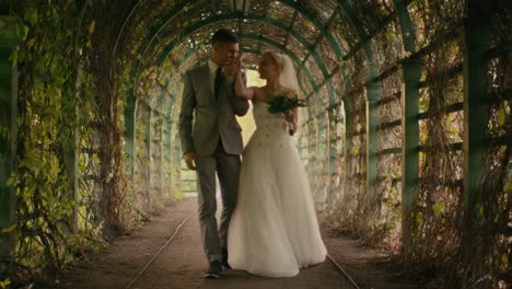 Happy-young-newlyweds-are-walking-in-a-park.