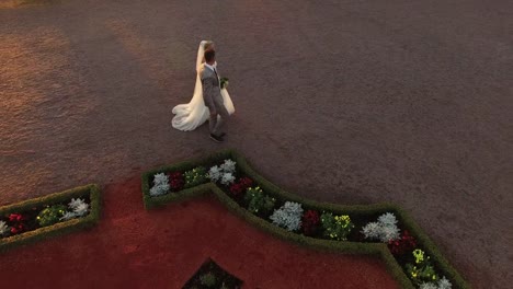 Aerial-drone-shot-of-a-just-marries-couple-moving-to-the-mansion.