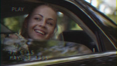 Young-beautiful-happy-bride-sits-in-a-car-and-waves-out-of-the-window.