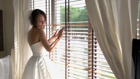 Bride-standing-near-window.