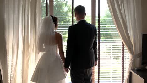 Bride-and-groom-beside-window.