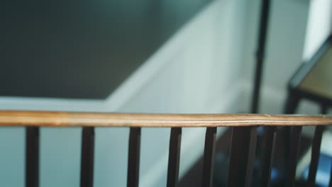 A-Man-Walking-Up-the-Stairs-Holding-the-Bannister