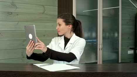 Happy-spa-manager-taking-selfies-with-her-tablet-at-the-reception-desk