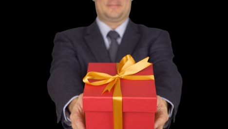 Businessman-present-red-gift-box-with-ribbon-bow,-front-view,-isolated-over-transparent-background.