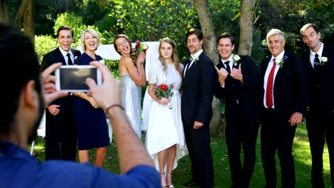 Photographer-taking-photo-of-bride-and-groom-with-there-family-4K-4k