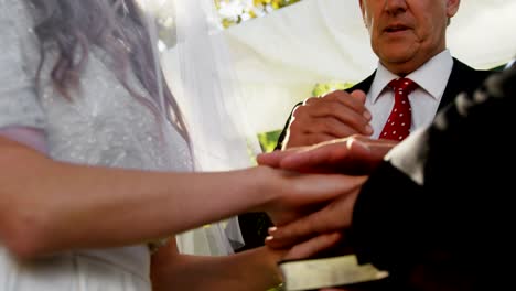 Priest-giving-blessing-to-bride-and-groom-4K-4k