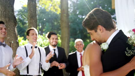 Bride-and-groom-happily-hugging-each-other-and-guests-clapping-4K-4k