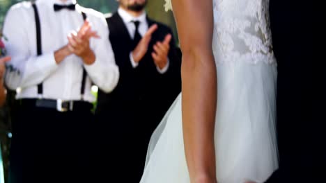 Groom-and-bride-standing-in-smiling,-holding-hands-in-wedding-day-4K-4k