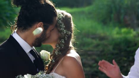 Bride-and-groom-kissing-and-in-background-guests-toss-petals-4K-4k