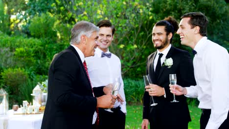 Father-of-the-Bride-having-champagne-with-groom-and-guest-4K-4k