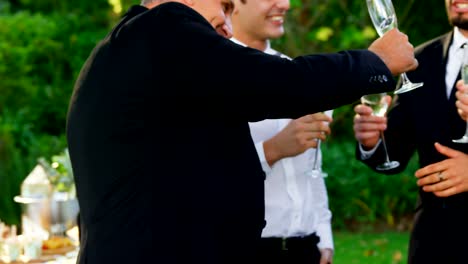 Father-of-the-Bride-toasting-champagne-with-groom-and-guest-4K-4k