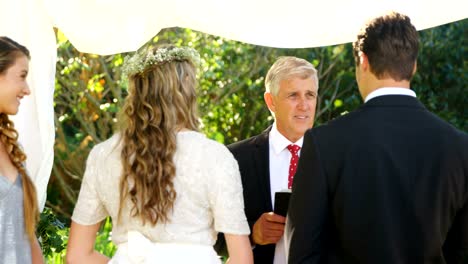 Priest-talking-to-the-bride-and-groom-4K-4k