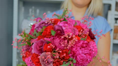 Professionellen-Floristen-halten-und-zeigen-Blumenstrauß-im-studio