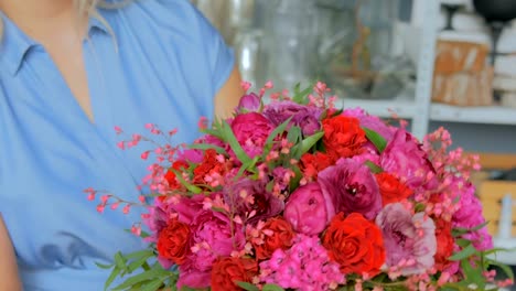 3-shots.-Professional-florist-holding-and-checking-bouquet-at-studio