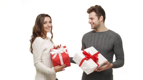 4k-Young-couple-showing-and-exchanging-presents-in-Chrismas-day-on-white-background.