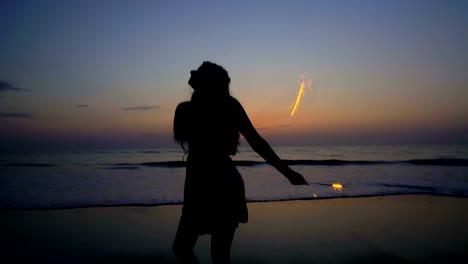 Silhouette-of-Asian-Indian-girl-celebrating-with-sparklers